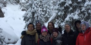 group of people in snowy forest