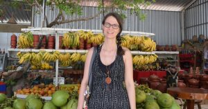 Woman standing in front of fruit stand