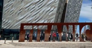 People standing before the Titanic museum in Belfast, Northern Ireland.